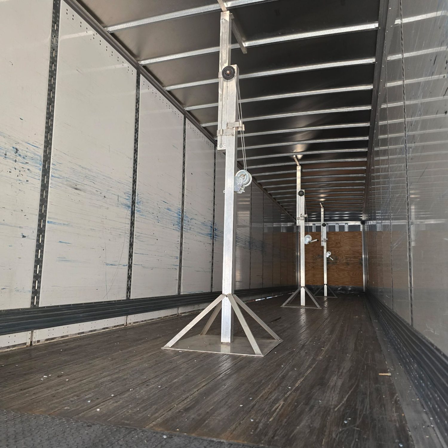 Roof supports in place inside a trailer during roof replacement